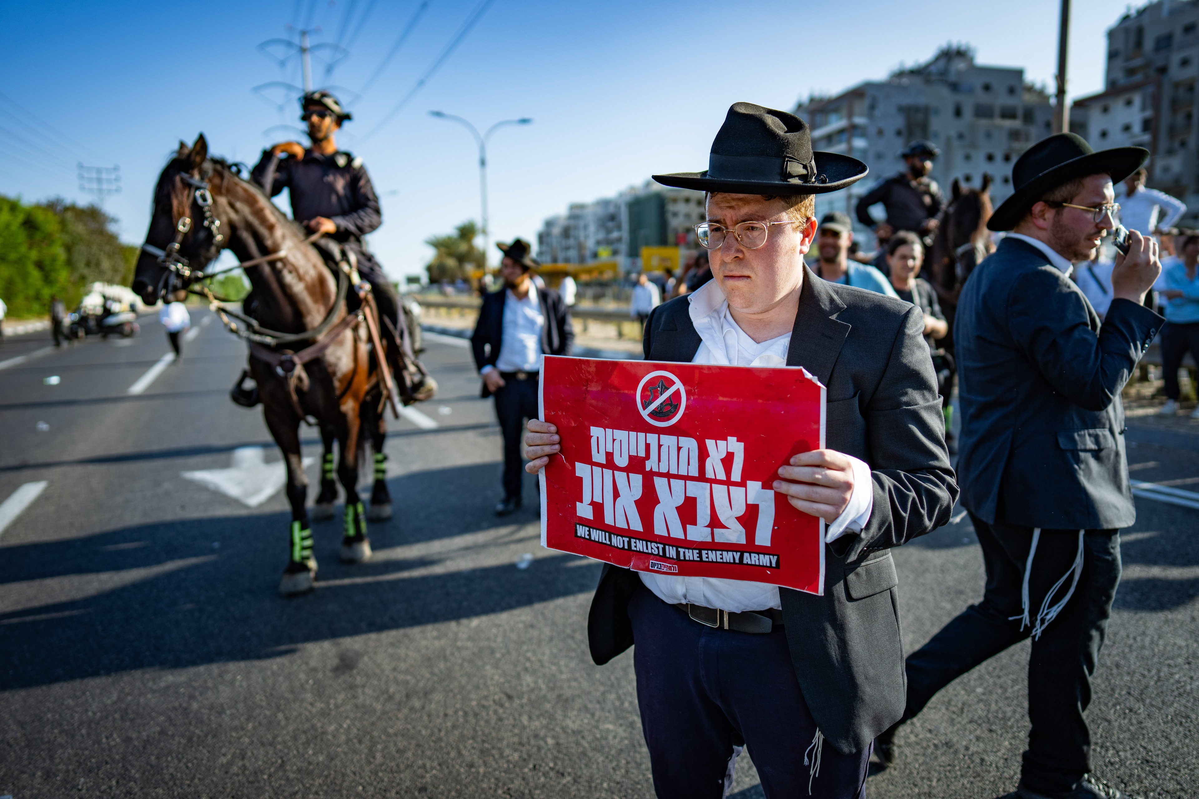 "We won't enlist in the enemy army." Haredi protest against the draft. "We won't enlist in the enemy army." Haredi protest against the draft.